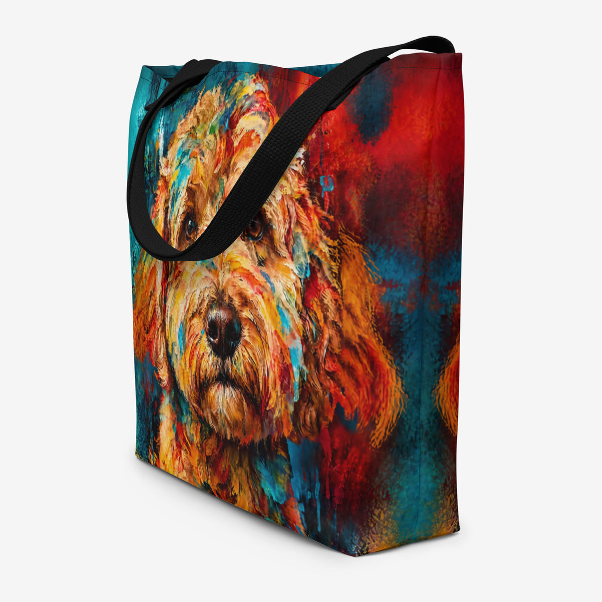 A side, angled view of a tote bag featuring a colorful, textured painting of a goldendoodle's face, with black shoulder straps, shown on a light gray background.