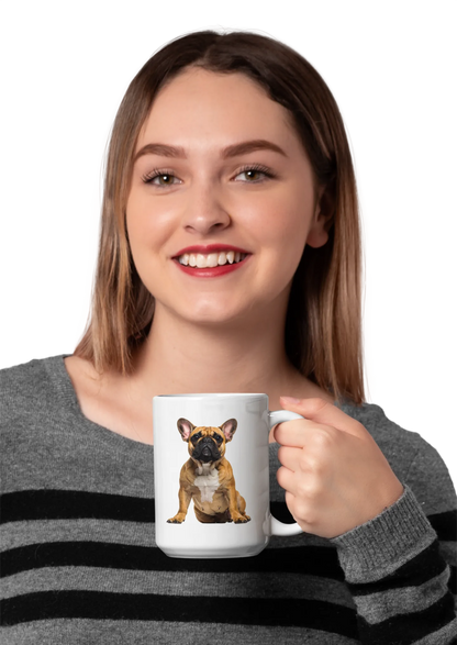 A smiling woman with light brown hair holds a white ceramic mug featuring a printed illustration of a French bulldog. She is wearing a gray and black striped knit sweater against a plain white background.