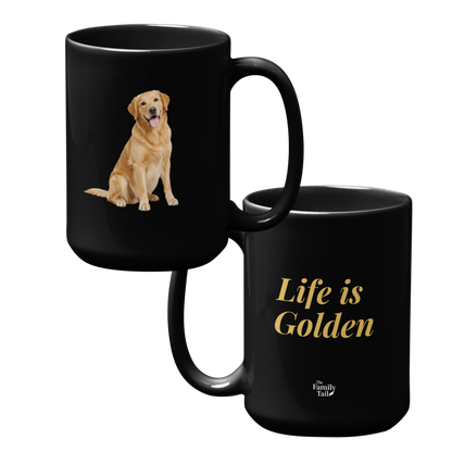 Both sides of a black ceramic mug - one side displaying a graphic of a golden retriever dog and the other side featuring the gold text 'Life is Golden' with a small 'The Family Table' logo at the bottom.