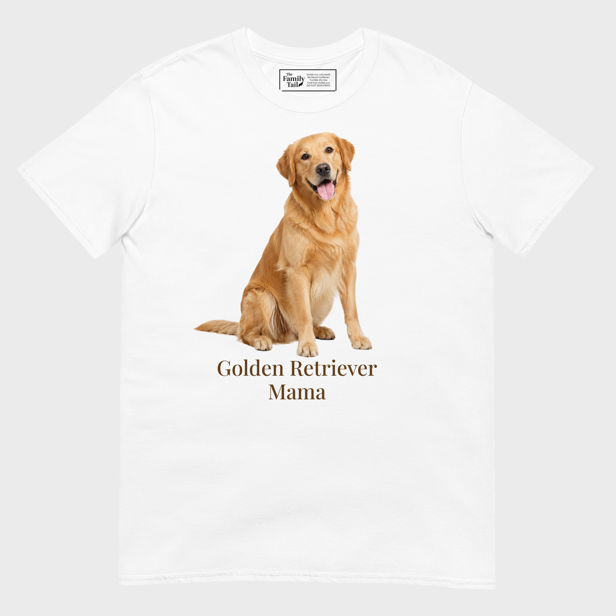 A white short-sleeve crewneck t-shirt featuring a graphic print of a golden retriever dog sitting above the text 'Golden Retriever Mama' in a dark brown font on a light gray background.