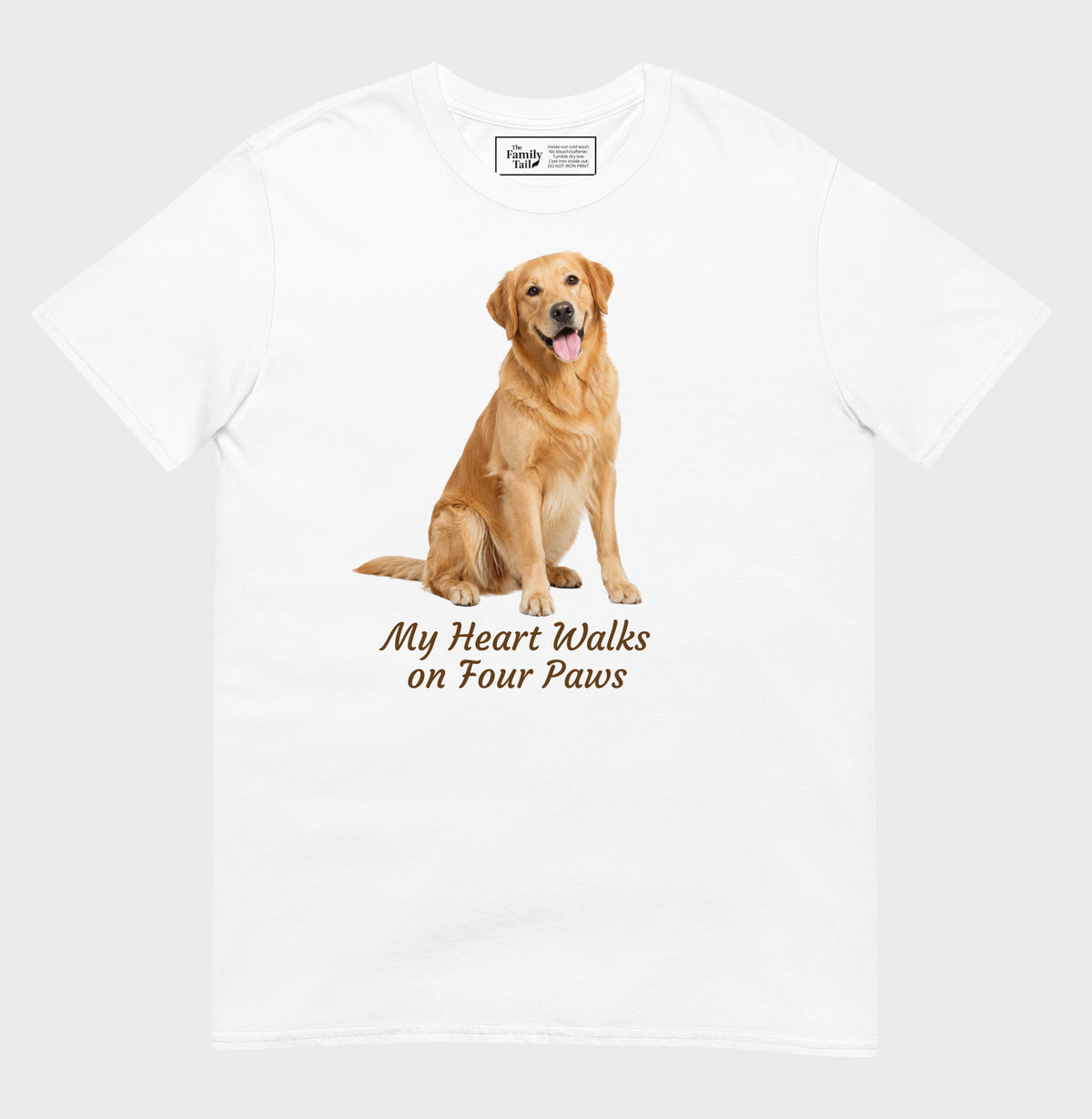 A white short-sleeve crewneck t-shirt featuring a graphic of a golden retriever dog sitting down with the text 'My Heart Walks on Four Paws' printed below it.