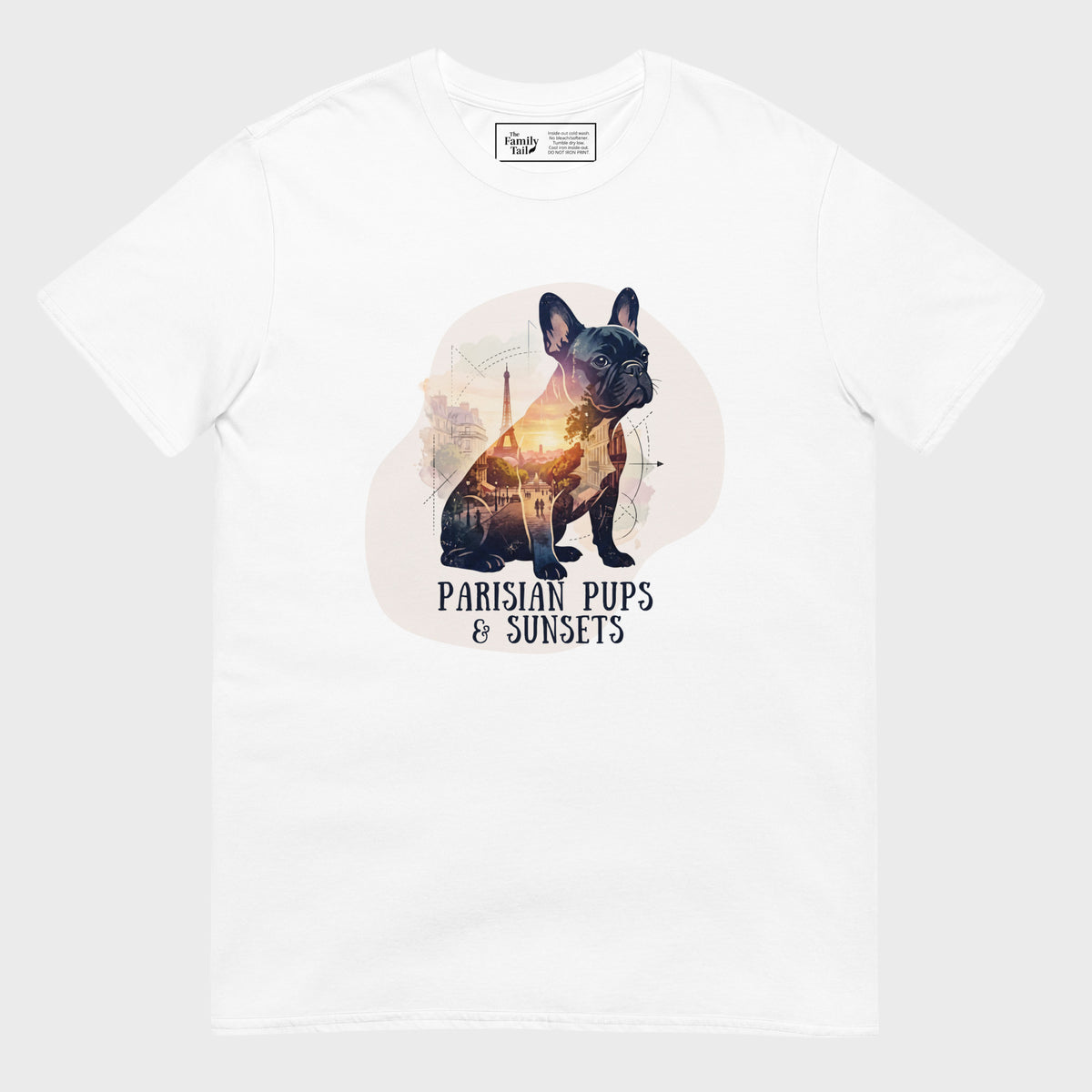 A white short-sleeve crewneck t-shirt featuring a graphic print of a French Bulldog with a sunset-filled silhouette and the text 'PARISIAN PUPS & SUNSETS' printed below it.