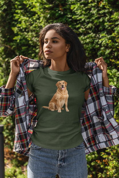 A woman outdoors wearing a forest green t-shirt with a graphic of a golden retriever dog, holding a black, red, and white plaid flannel shirt open over her shoulders. She is wearing blue jeans, with a background of green foliage.