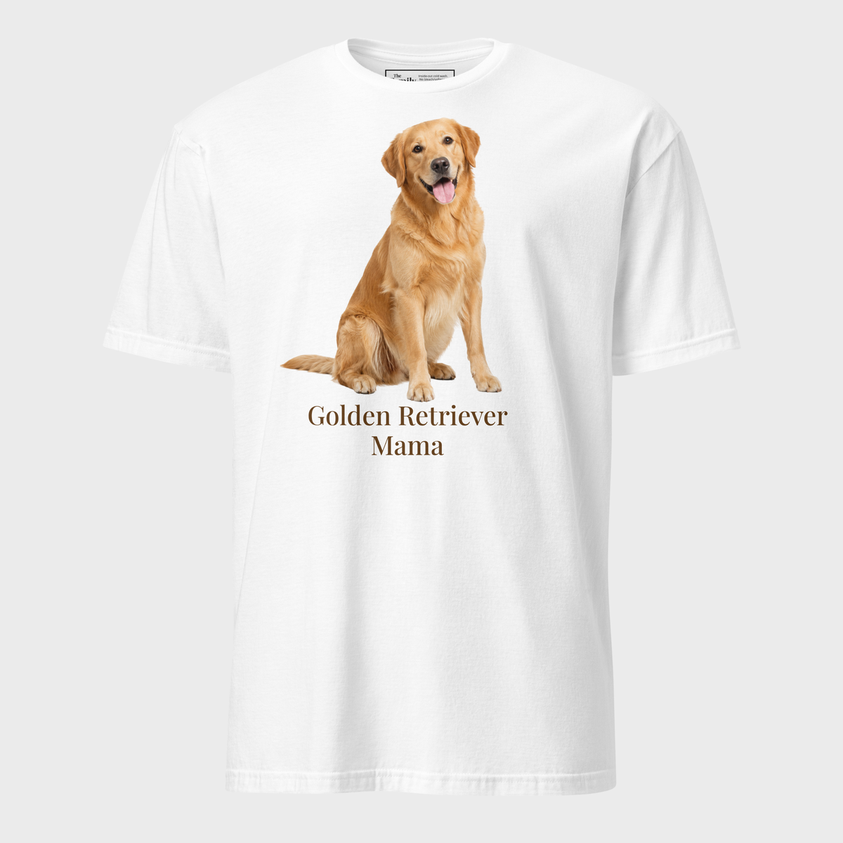 A white short-sleeve crewneck t-shirt featuring a graphic print of a golden retriever dog sitting above the text 'Golden Retriever Mama' in a dark brown font on a light gray background.
