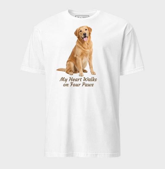 A white short-sleeve crewneck t-shirt featuring a graphic of a golden retriever dog sitting down with the text 'My Heart Walks on Four Paws' printed below it.
