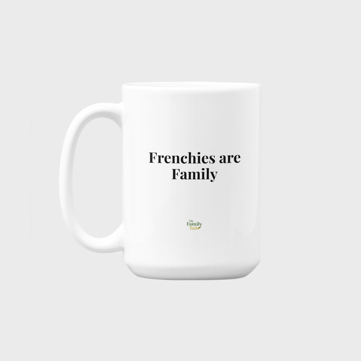A white ceramic mug with the text 'Frenchies are Family' printed in black sans-serif font, with a small green and yellow logo underneath, set against a solid light gray background.