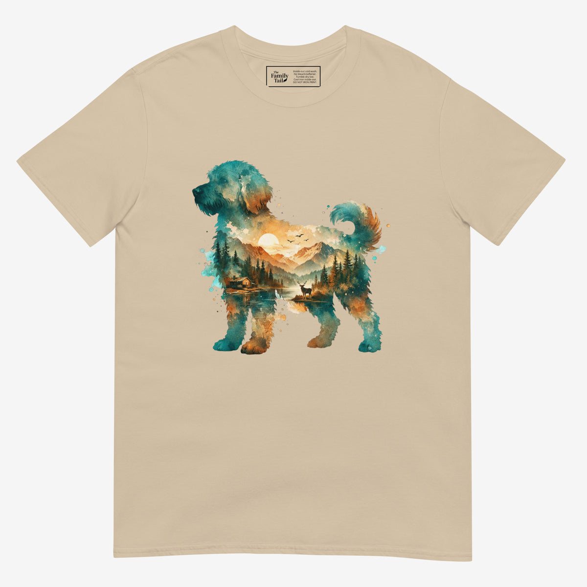 A sand colored short-sleeve crewneck t-shirt featuring a watercolor-style graphic of a goldendoodle dog silhouette filled with a scenic landscape of mountains, trees, and a lake.